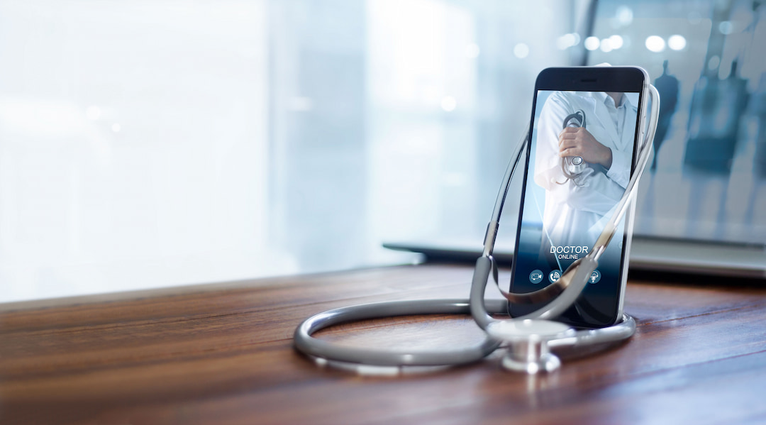 a cell phone showing a doctor on screen 