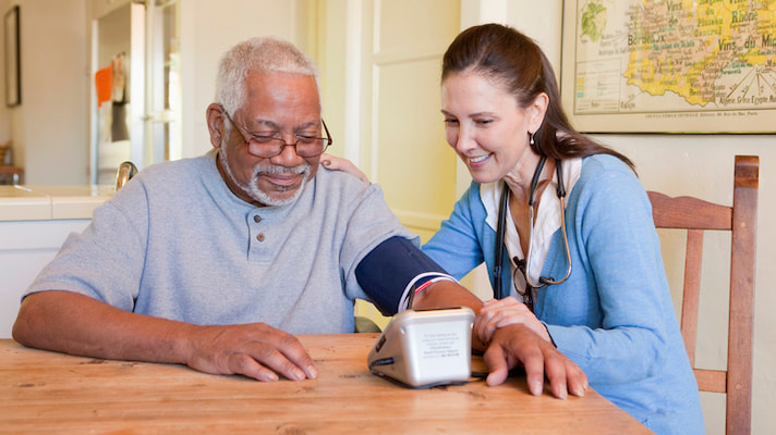two elderly person with a sphygmomanometer